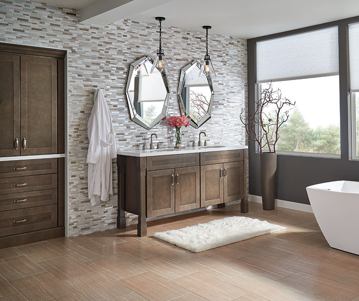 bathroom with mixed tile backsplash and wooden cabinetry