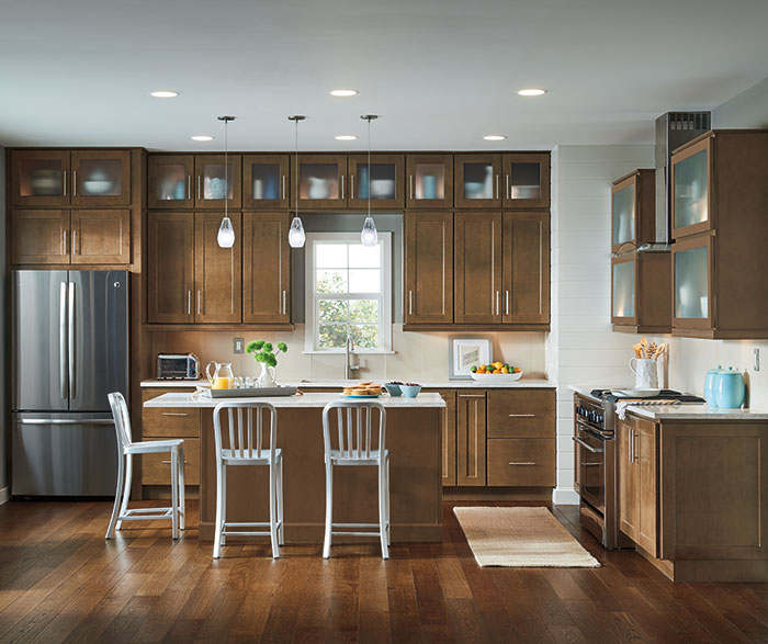 kitchen with natural wooden floors and cabinetry